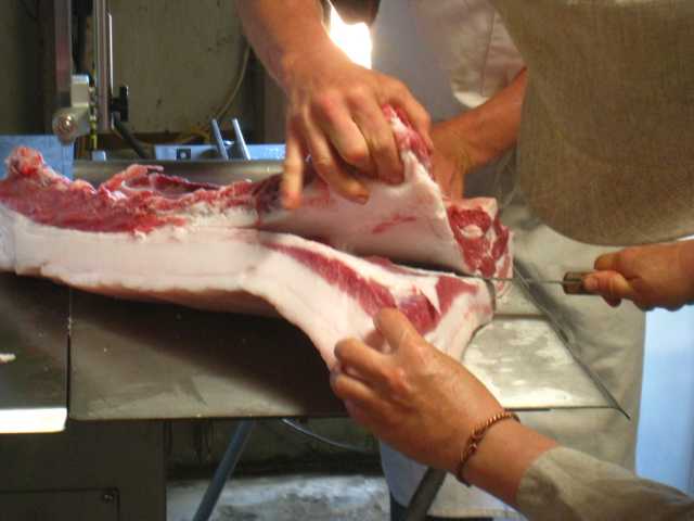 Slicing meat away from bacon